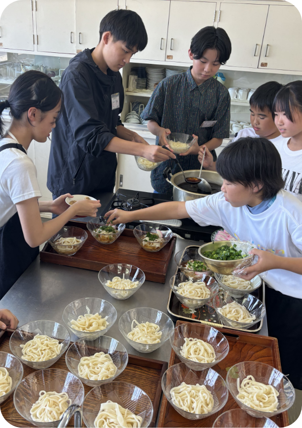 うどんを配膳する子供達
